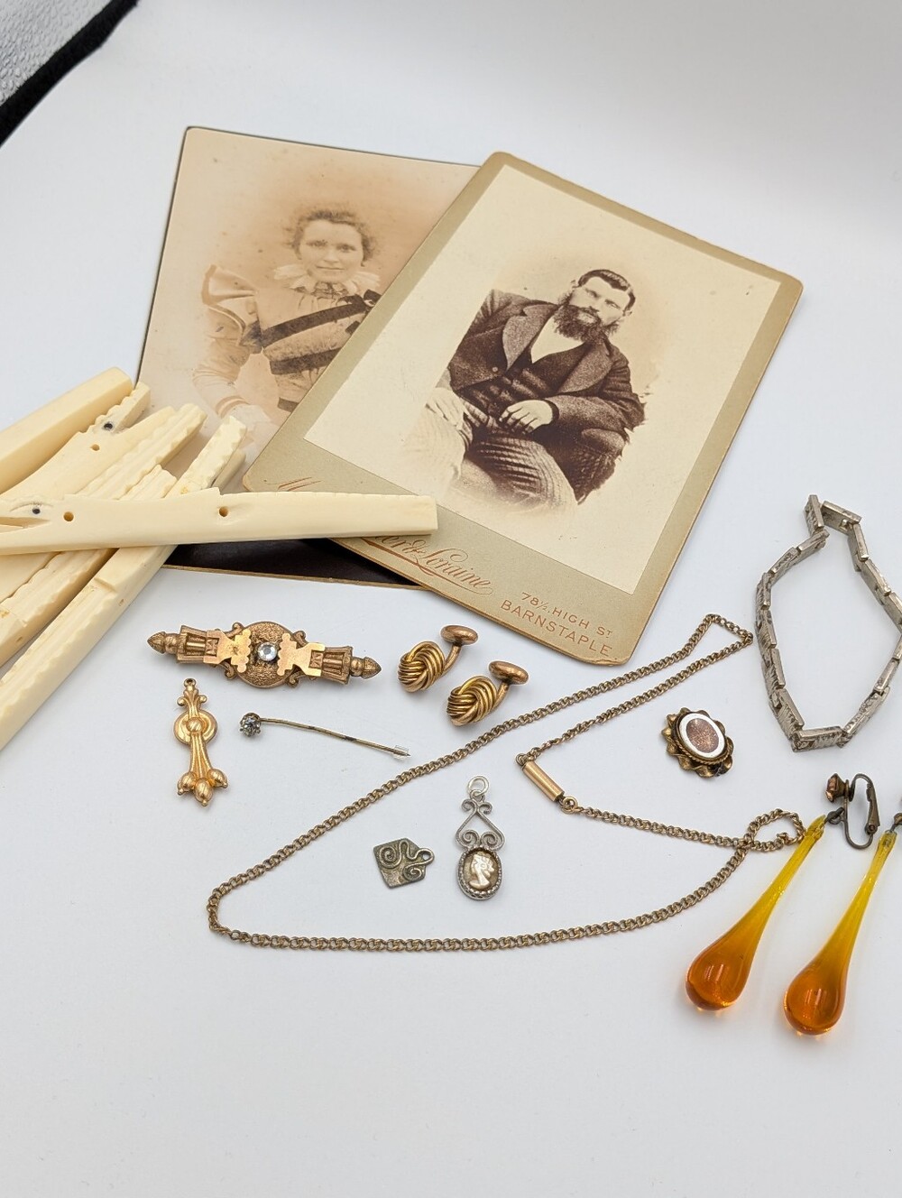 Antique lot of items including cabinet cards, pendants, brooches, and more